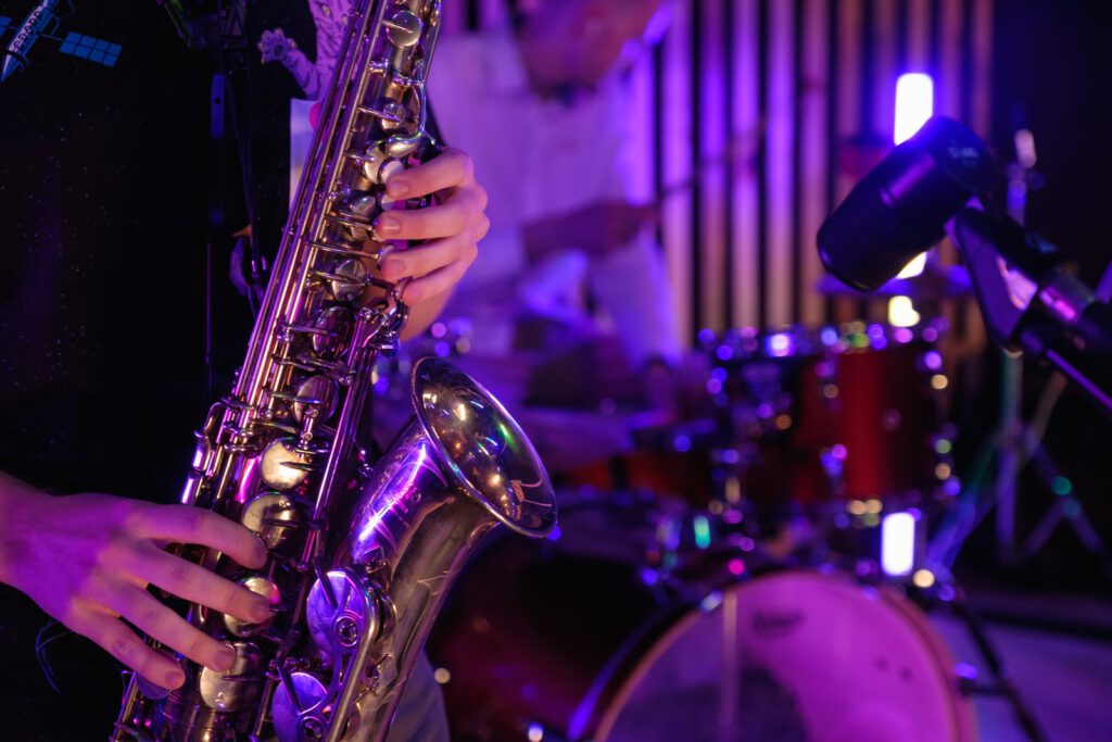 Person Playing Brass Saxophone on Stage